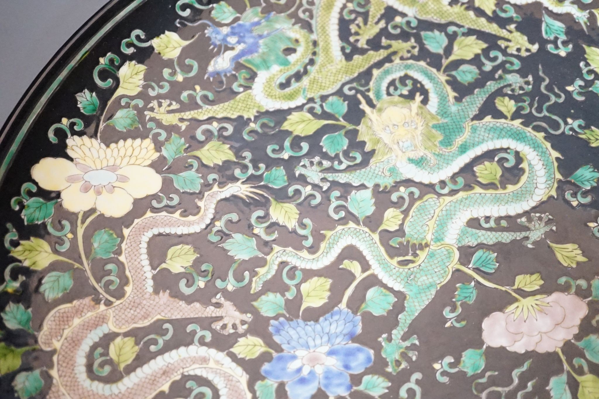 A large Chinese black ground 'dragon' dish, 43cm